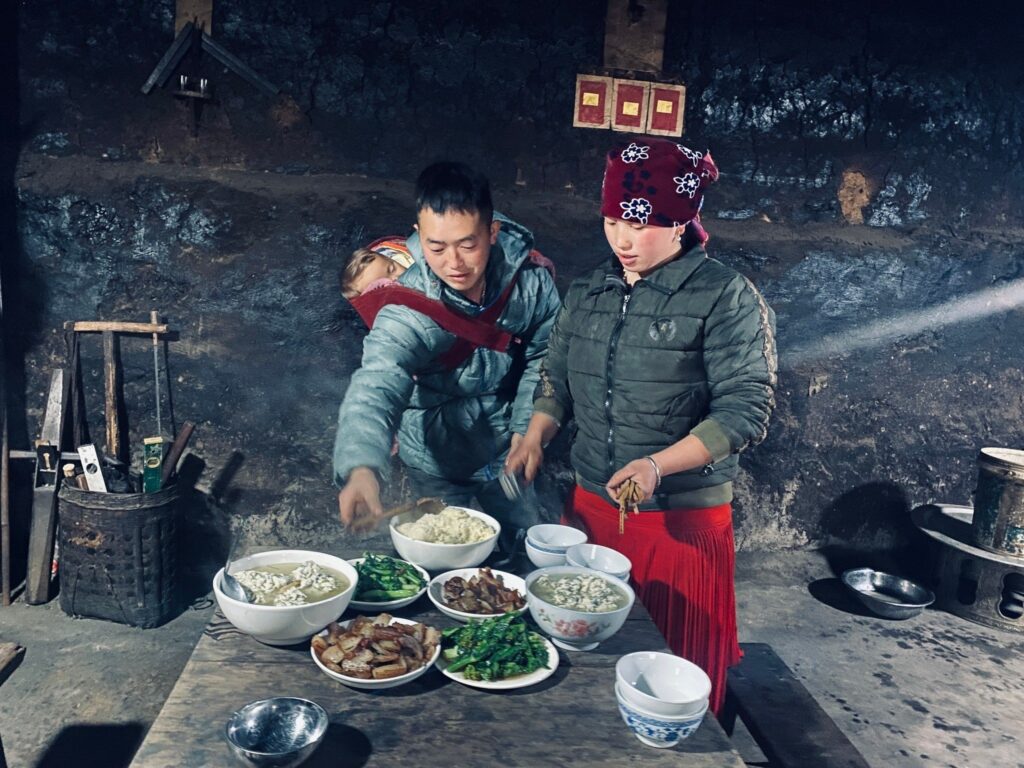 The owners prepare dinner with typical Hmong food in Lao Xa Old House Homestay